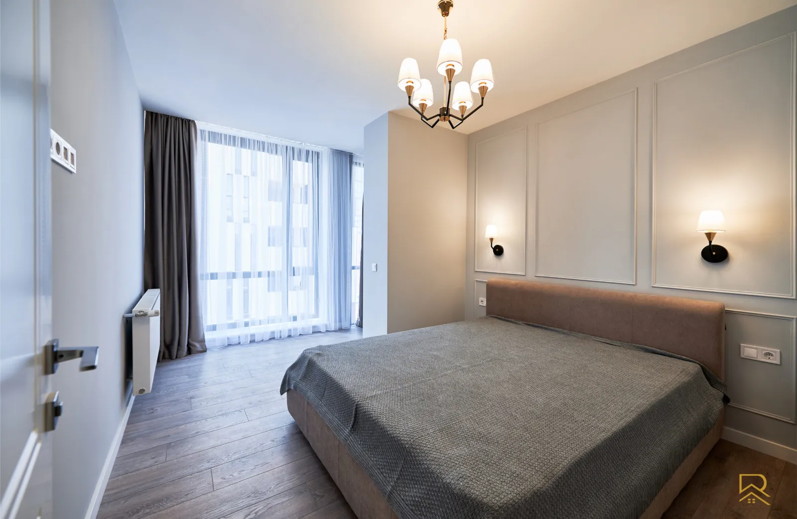 Bedroom after renovation in Trafford – panelled feature wall, new flooring and lighting