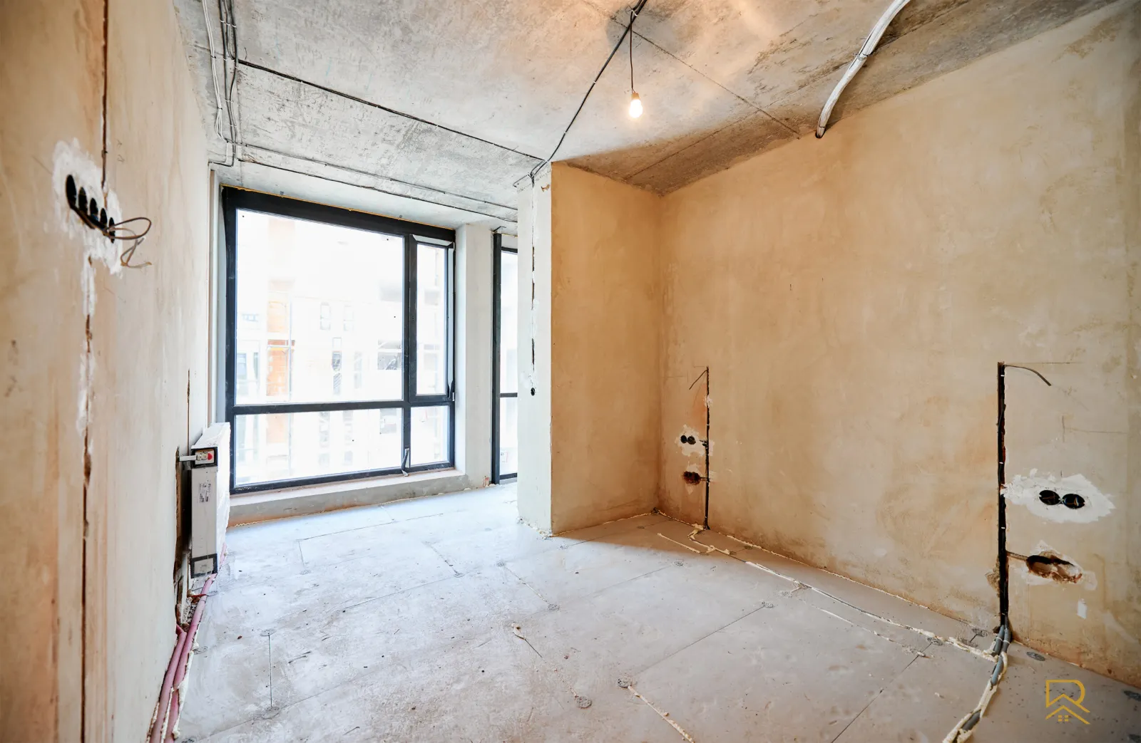 Bedroom before renovation in Trafford – bare plaster walls and concrete floor