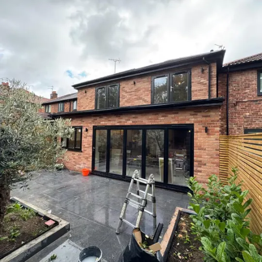Double storey rear extension with bi-fold doors and new patio in Trafford
